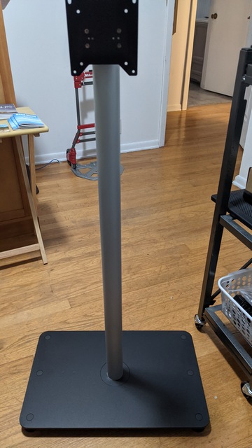 Run any cables up through access hole in stand base and pole and stand upright